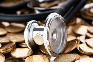 Concept of expensive health care with coins and stethoscope