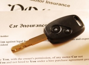 Car key on an insurance policy. Toned warm.